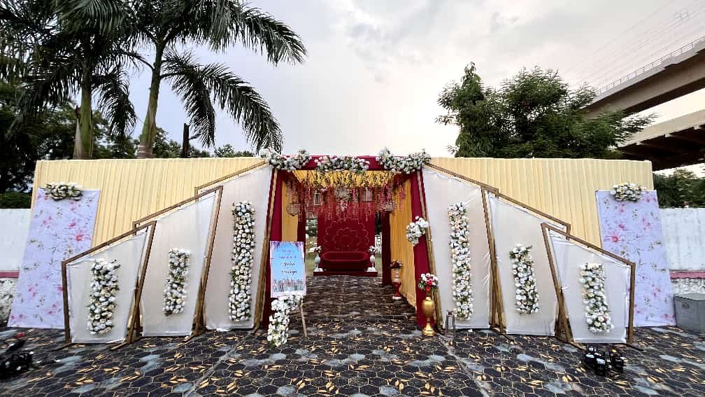 Decorated outdoor event entrance with tent setup
