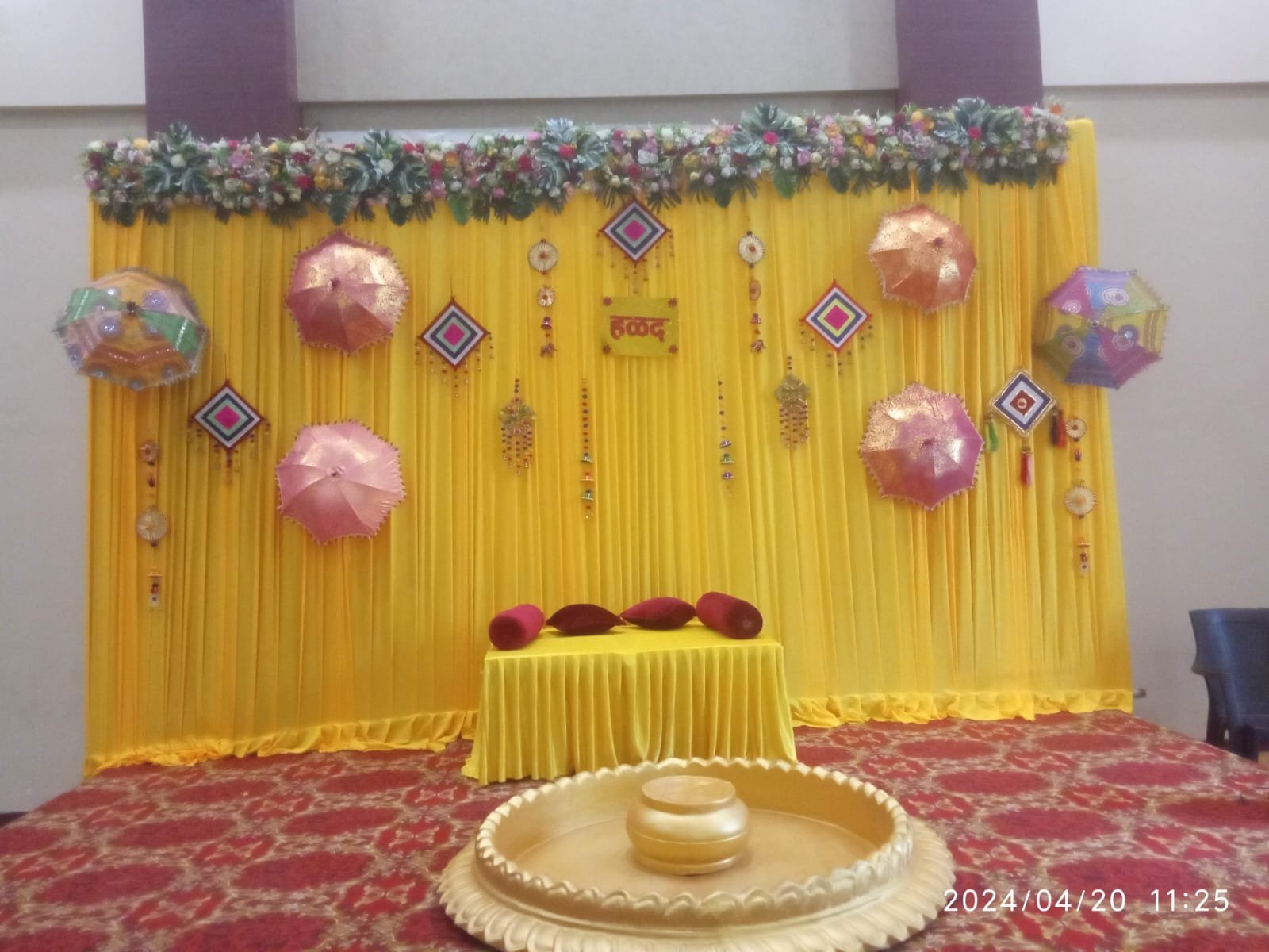 Yellow themed event stage with seating and decor